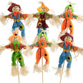 Six assorted fabric scarecrow decorations with straw accents and button details, displayed against a white background.