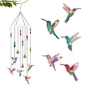 Diamond painting hummingbird wind chime with bells and beads hanging from a branch