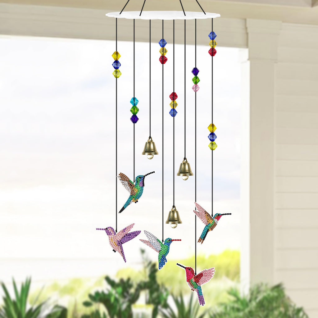 Diamond painting hummingbird wind chime with colorful beads and bells hanging outdoors