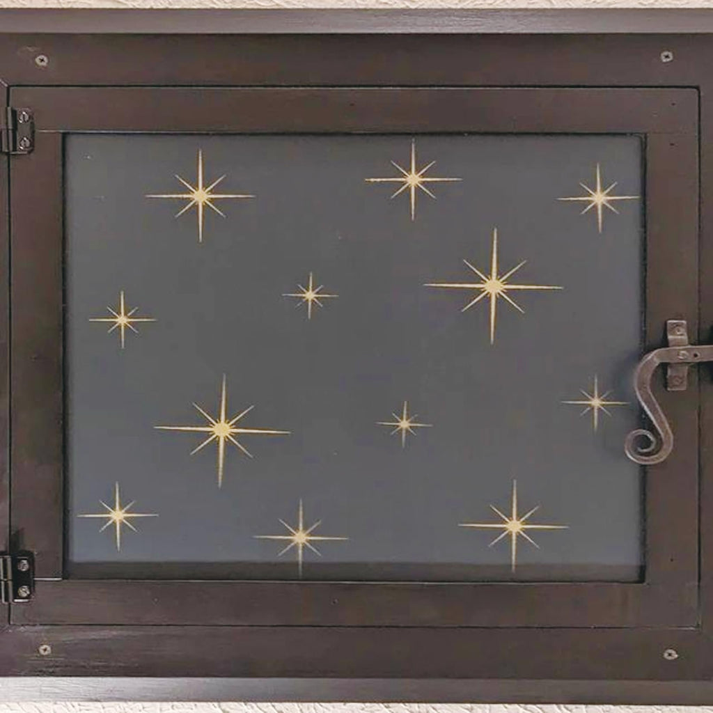Dark brown wooden frame with a dark gray inset panel decorated with scattered gold starbursts.