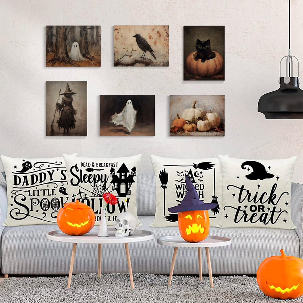 Six vintage Halloween canvas art prints displayed on a wall above a sofa with Halloween-themed pillows and pumpkins.