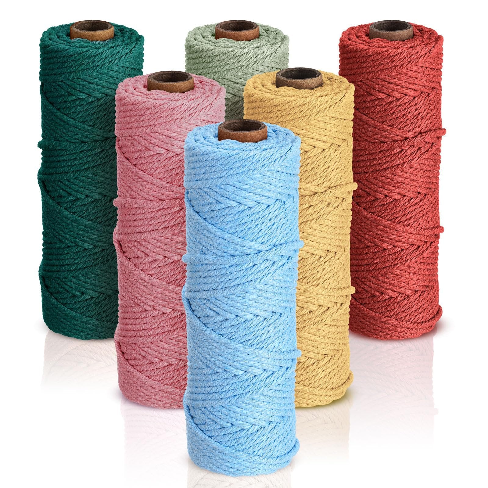 Six spools of 3mm cotton macrame cord in various colors: teal, pink, light blue, sage green, yellow, and red, arranged in a staggered formation on a white background.