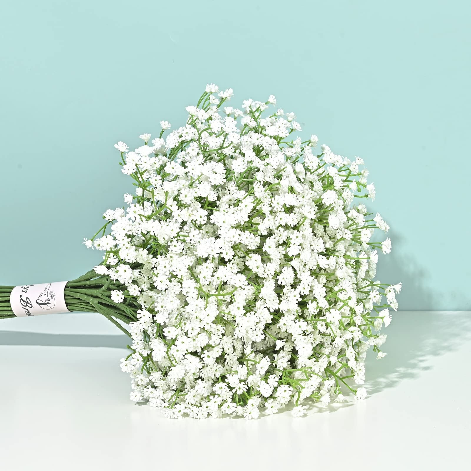 Bouquet of 6 stems of white artificial baby's breath flowers tied with a pink band