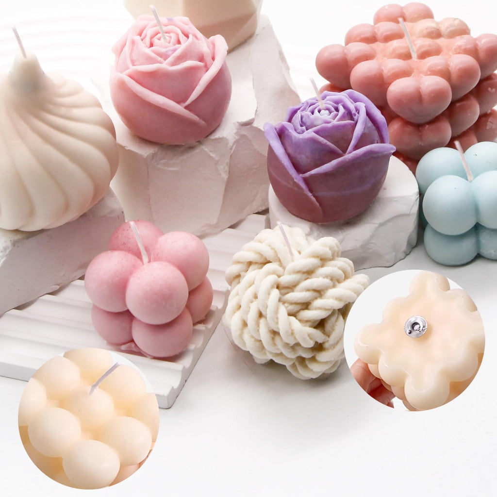 Assortment of decorative candles in various shapes including roses, bubbles, and rope texture, displayed on white geometric stands with inset close-ups.