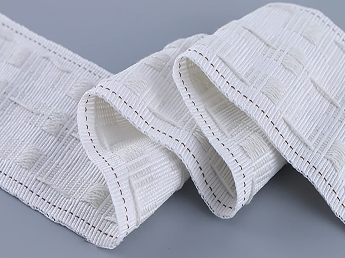 White curtain pleating tape with a woven checkered pattern and stitched edges, shown in a close-up, folded view on a gray background.