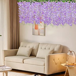 Artificial pink wisteria garland with 60 branches and silk blossoms draped above a sofa.