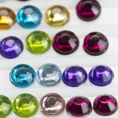 Close-up of colorful round flatback rhinestones for diamond painting, arranged in rows.