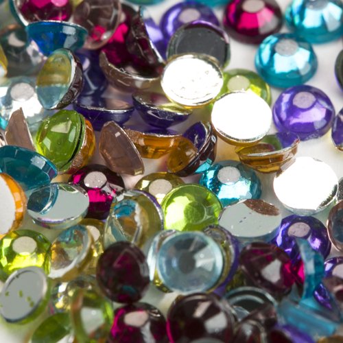 Close-up of colorful round flatback rhinestones for diamond painting, scattered on a white surface.