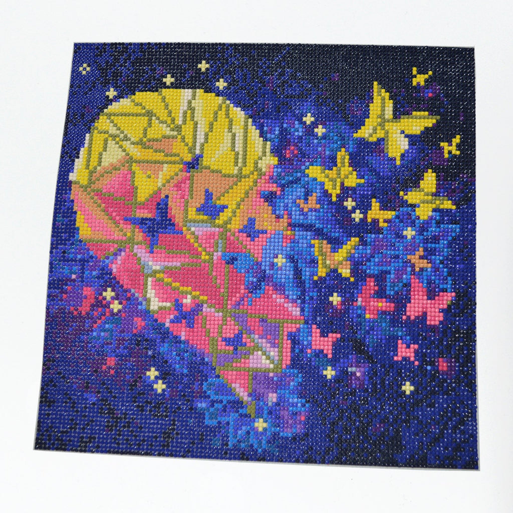 Diamond painting kit showing a heart shape with butterflies against a starry night sky, completed with colorful rhinestones.