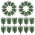 Artificial green pine needles arranged in two circular patterns and a grid of ten individual picks on a white background.