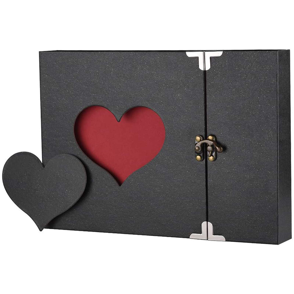 Black scrapbook album with a cutout heart revealing a red interior, featuring a decorative heart embellishment and a clasp closure.