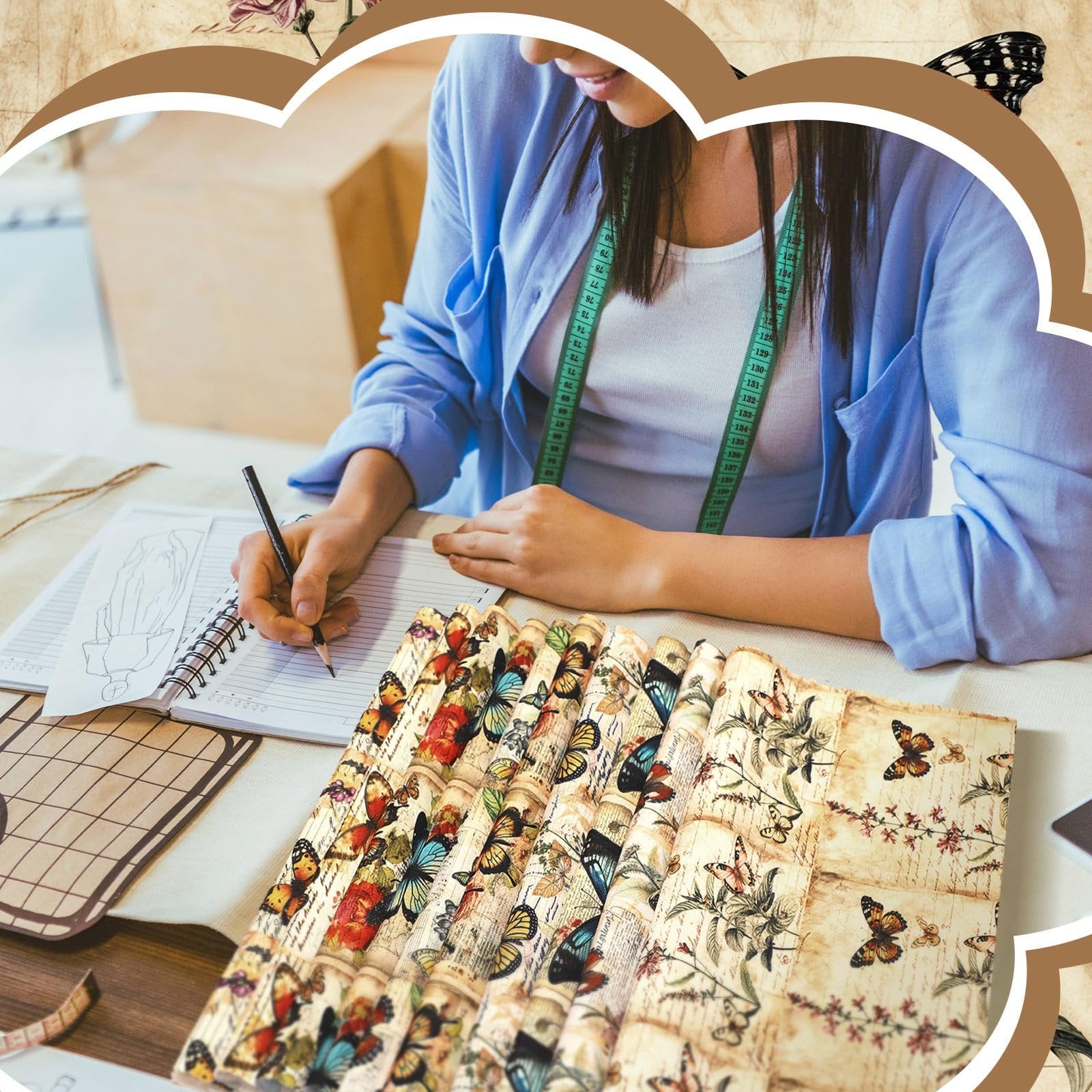 Woman sketching in notebook with vintage butterfly fabric squares in foreground