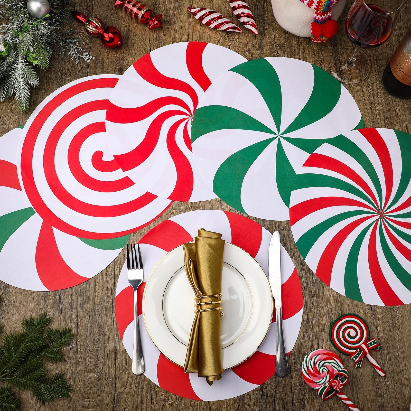 Christmas candy paper round placemats arranged on a wooden table with festive decorations