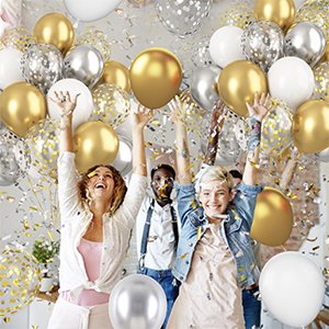 Group of people celebrating with metallic gold, silver, and white confetti balloons