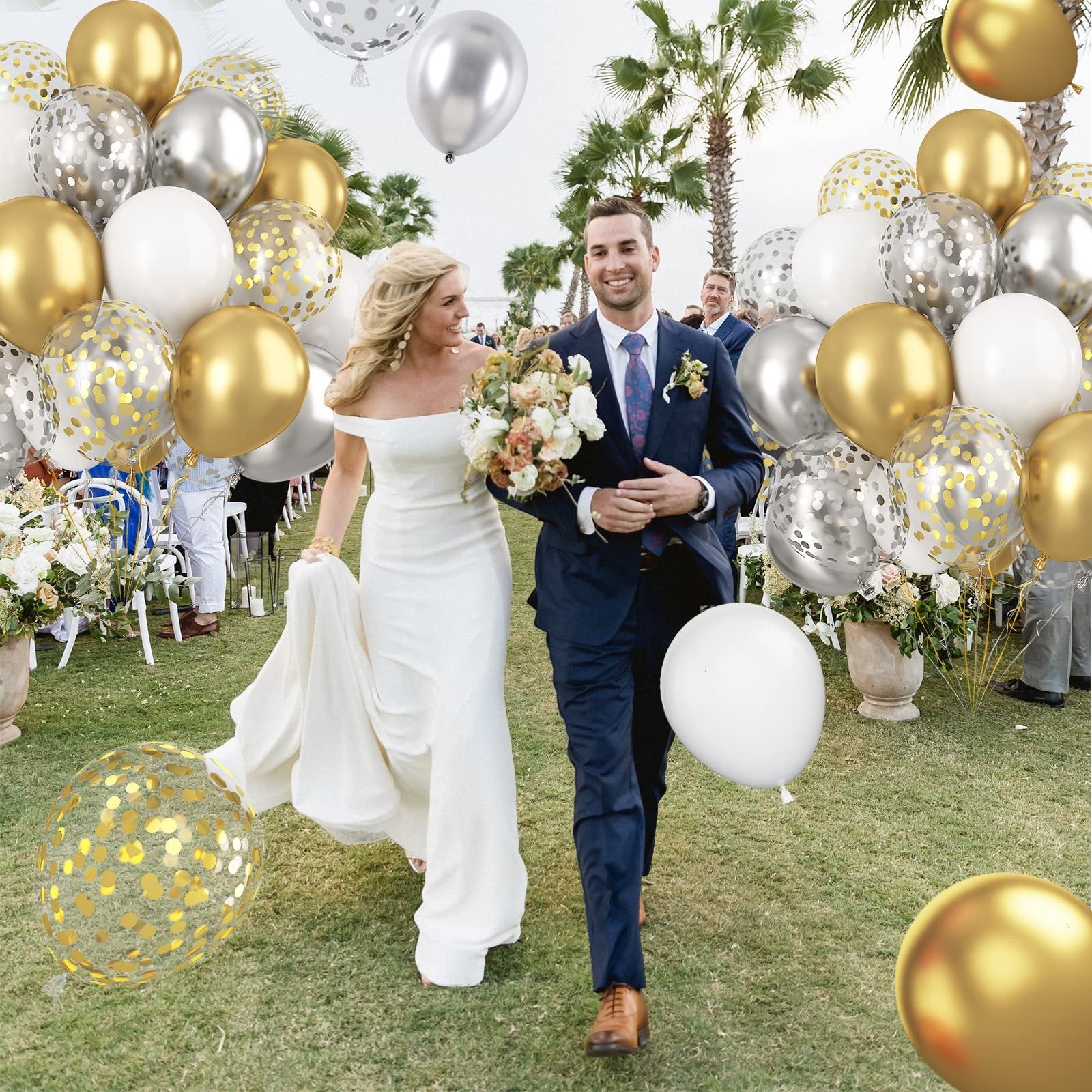 Wedding couple walking down aisle with metallic gold, silver, and white confetti balloons
