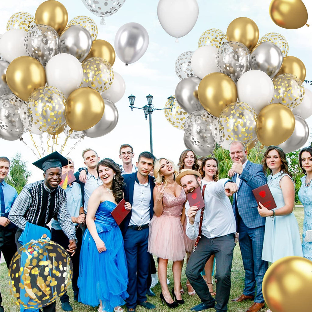 Group of young adults celebrating graduation with metallic gold, silver, and white balloons