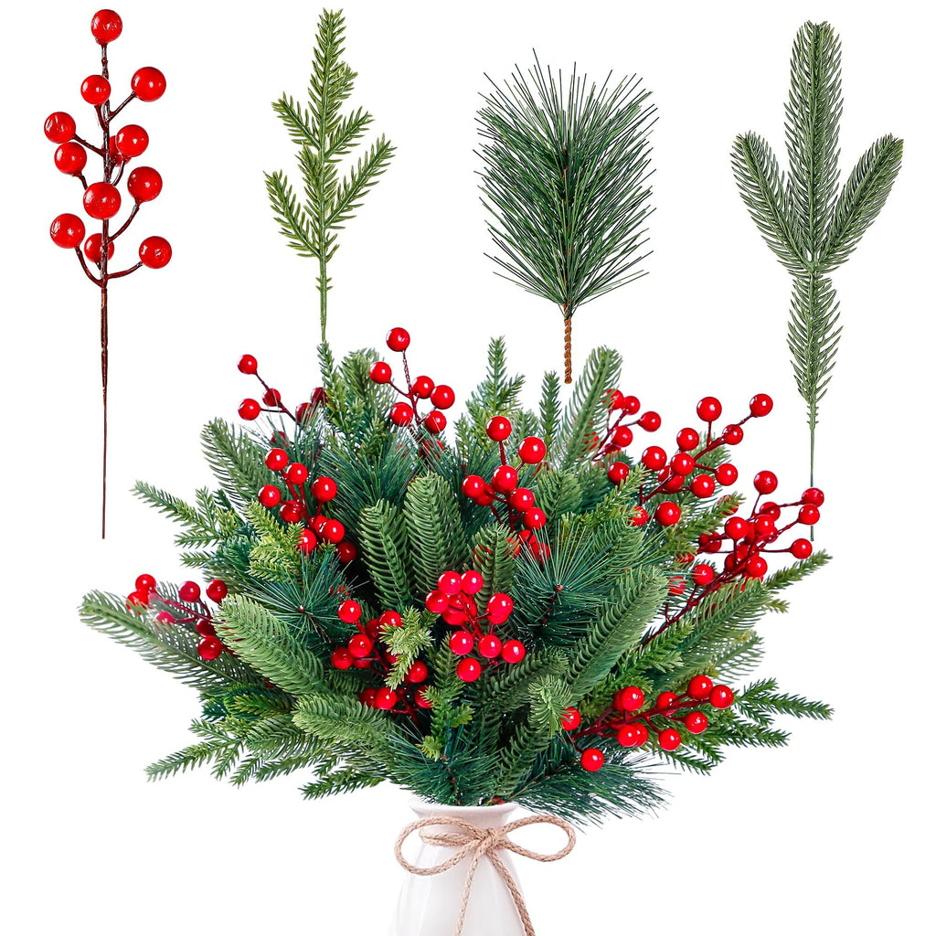 Artificial pine branches with red berries arranged in a white vase, with individual stems shown above.