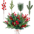 Artificial pine branches with red berries arranged in a white vase, with individual stems shown above.