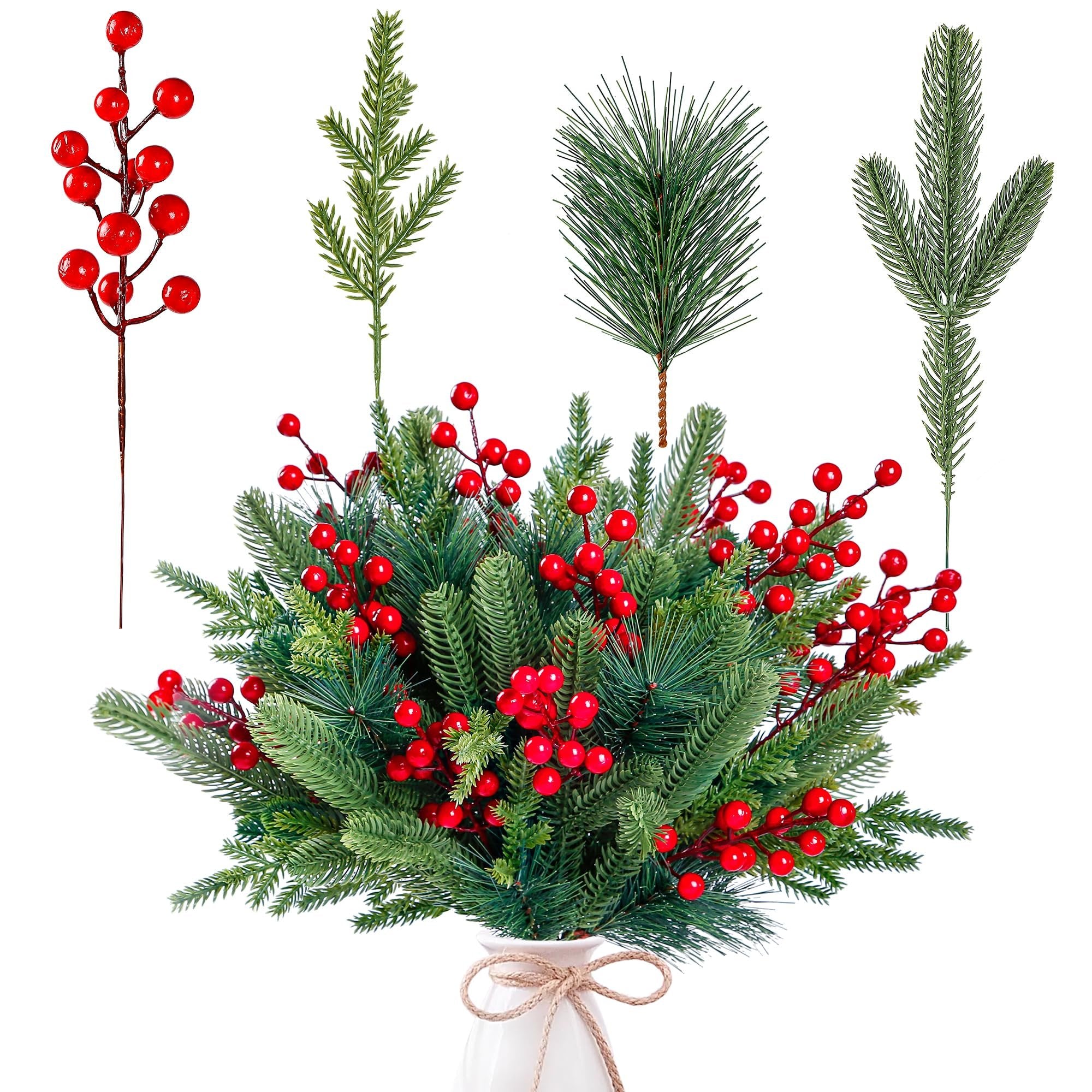 Artificial pine branches with red berries arranged in a white vase, with individual stems shown above.