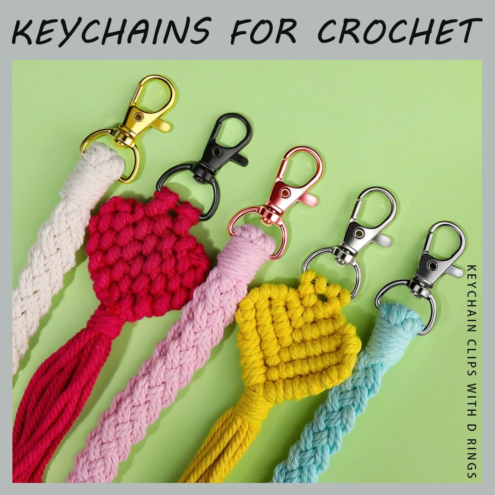 Assortment of five colorful crocheted heart keychains with metal clasps on a light green background.