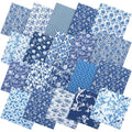 Collection of blue and white chinoiserie fabric squares with floral and bird patterns, fanned out.