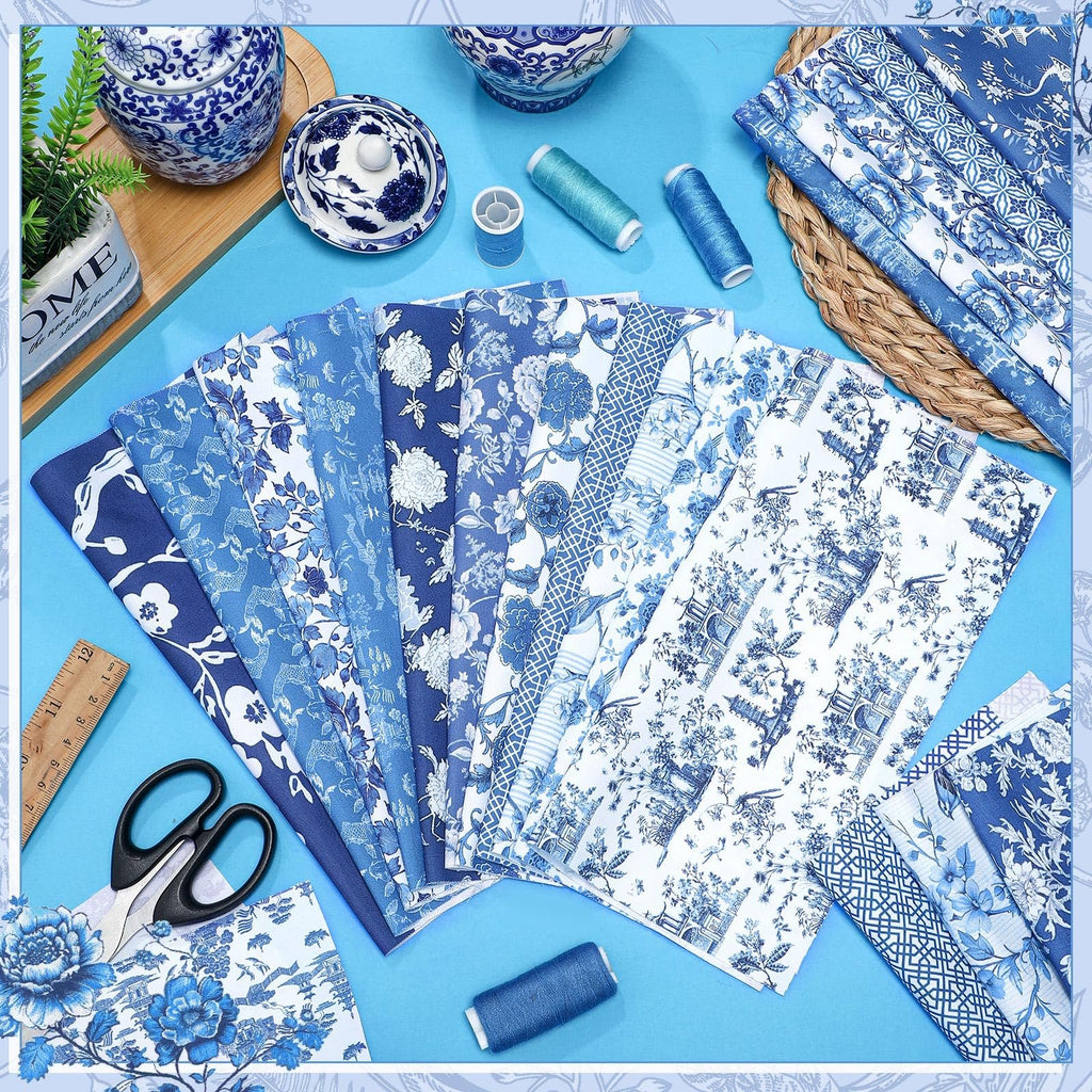 Collection of blue and white chinoiserie fabric squares fanned out with scissors and a ruler, plus spools of thread.