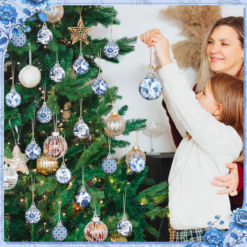 Mother and daughter decorating a Christmas tree with blue and white patterned ornaments.