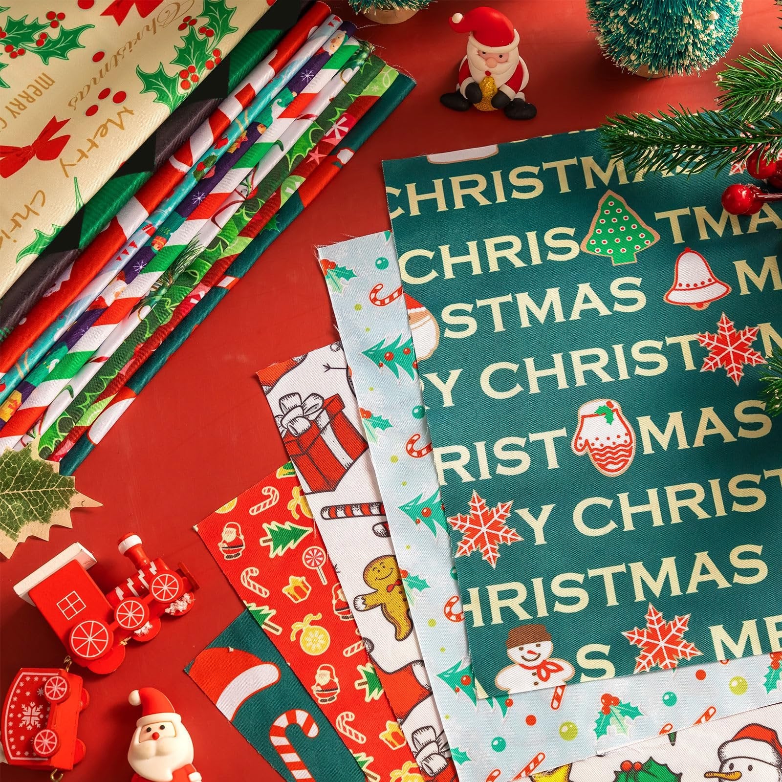 Stack of Christmas-themed fabric squares with various holiday prints like snowmen, trees, and candy canes, arranged on a red surface with festive decorations.