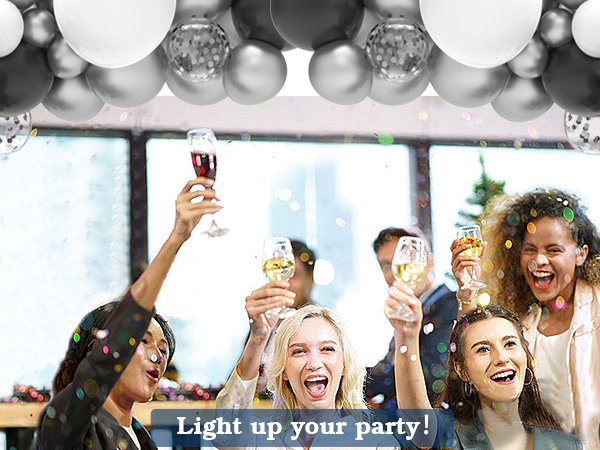 Group of people celebrating with champagne and balloons overhead