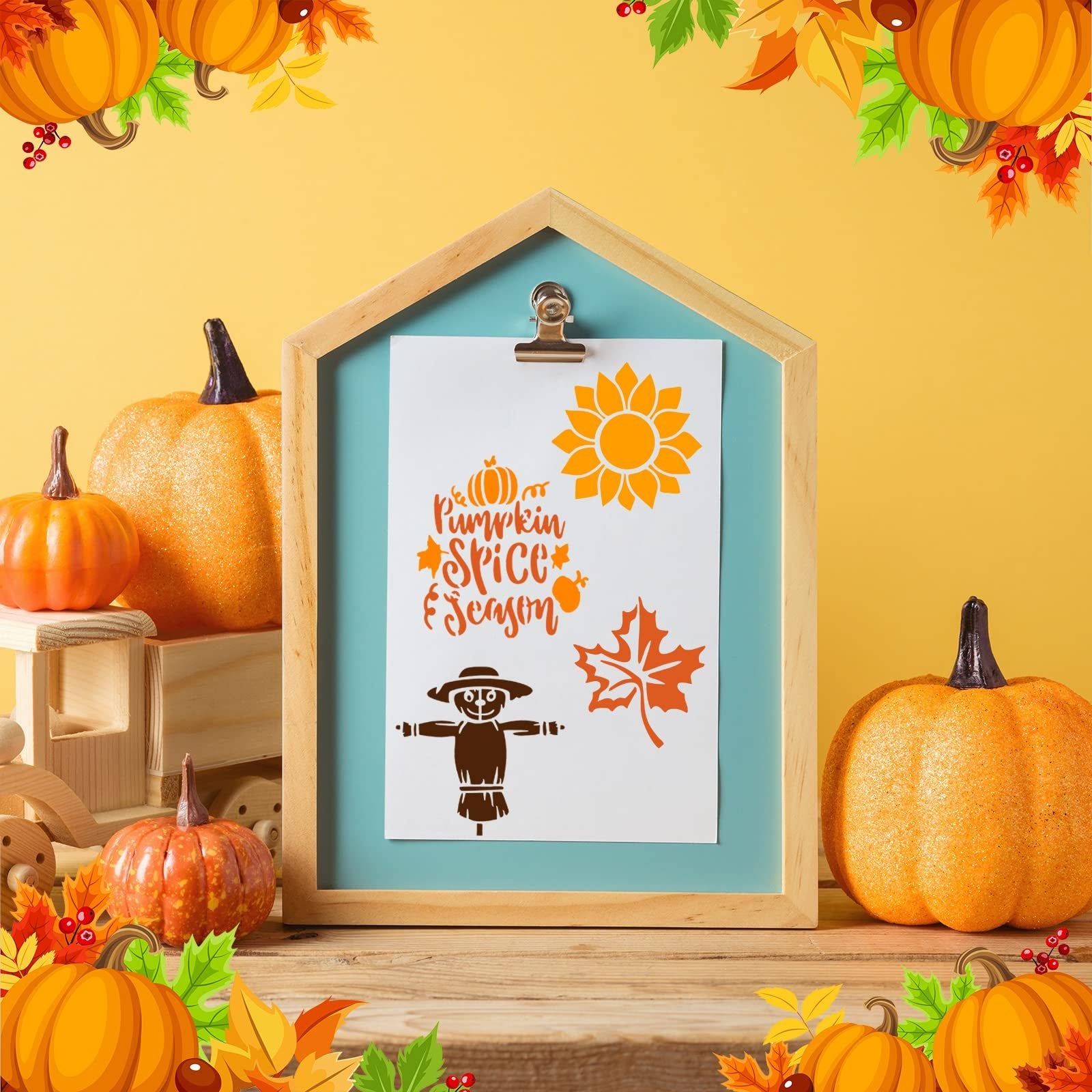 Fall themed stencils displayed on a clipboard with pumpkins and autumn leaves decoration