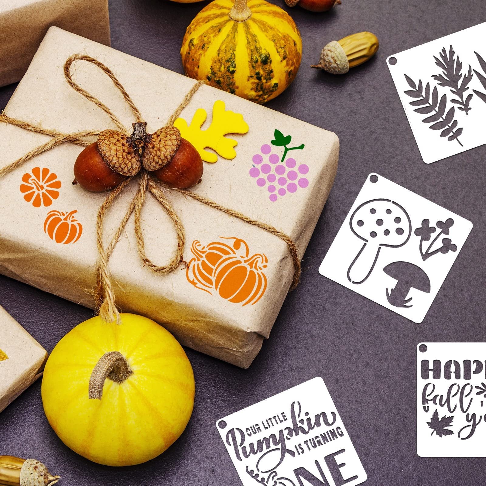 Fall themed stencils and decorative pumpkins arranged around a gift-wrapped package