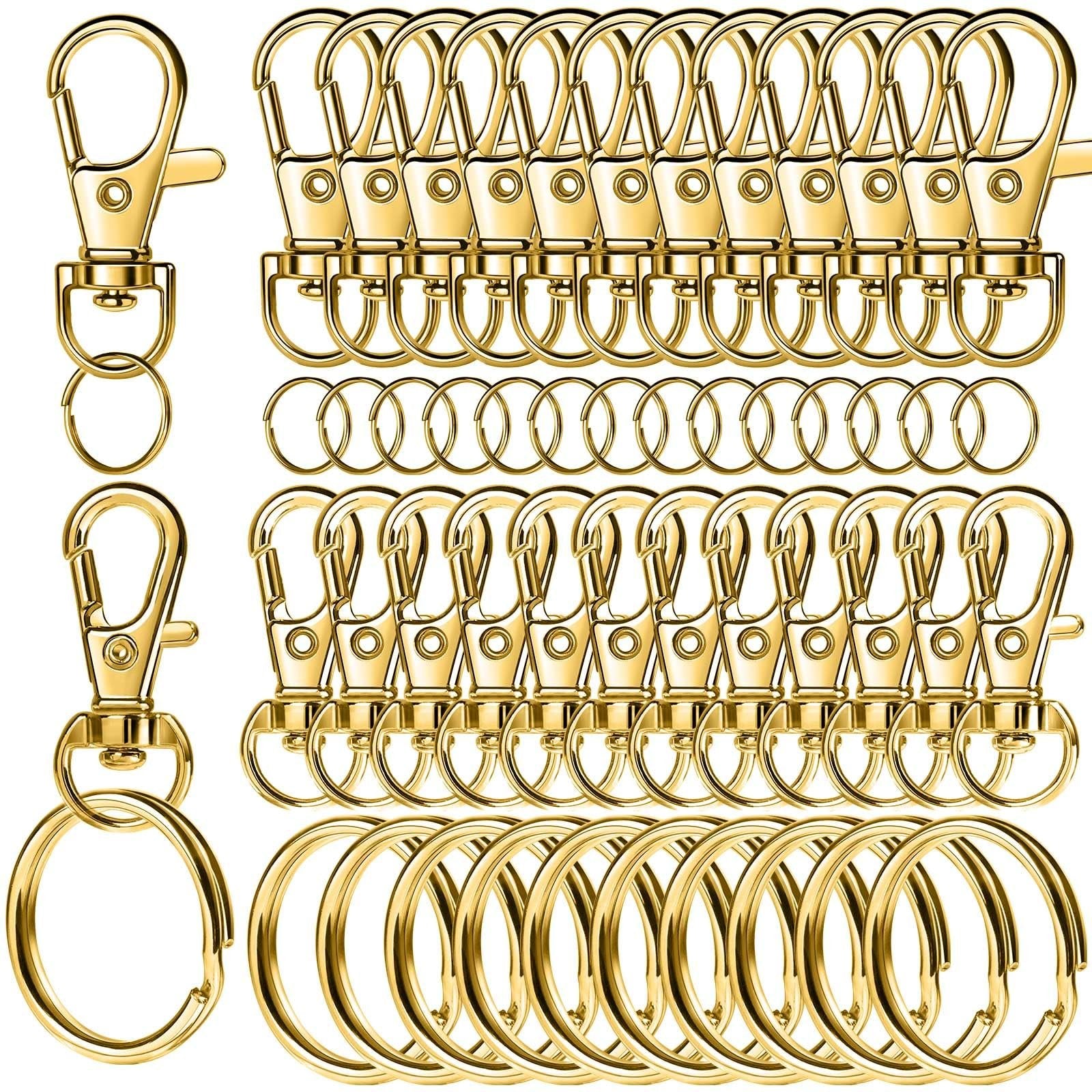 Gold swivel snap hooks and key rings arranged in rows on a white background.