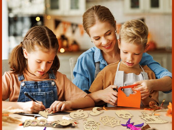 Mother and two children crafting Halloween wooden ornaments at a table, with various unfinished wood shapes scattered around.