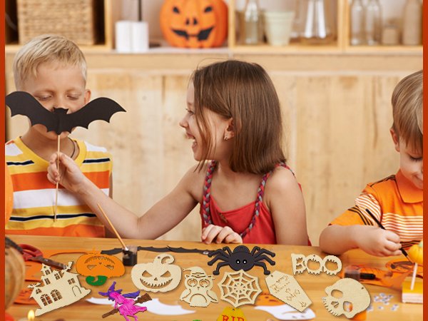 Children crafting Halloween wooden ornaments like pumpkins, skulls, and spiders on a table.