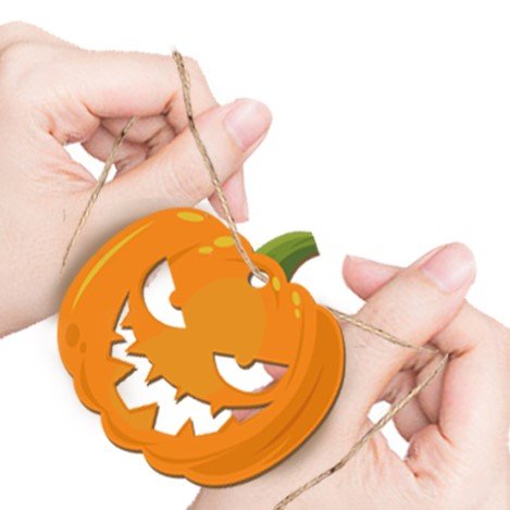 Hands holding a string attached to a carved Halloween pumpkin ornament, ready for decoration.