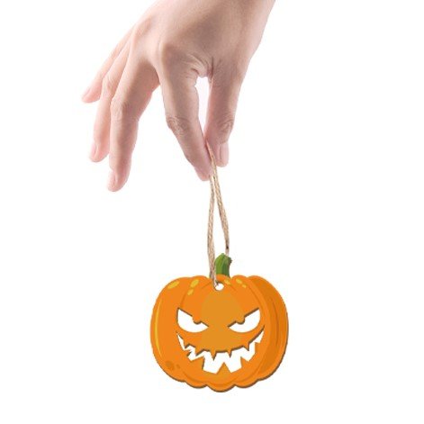 Hand holding a Halloween pumpkin ornament with a carved jack-o'-lantern face