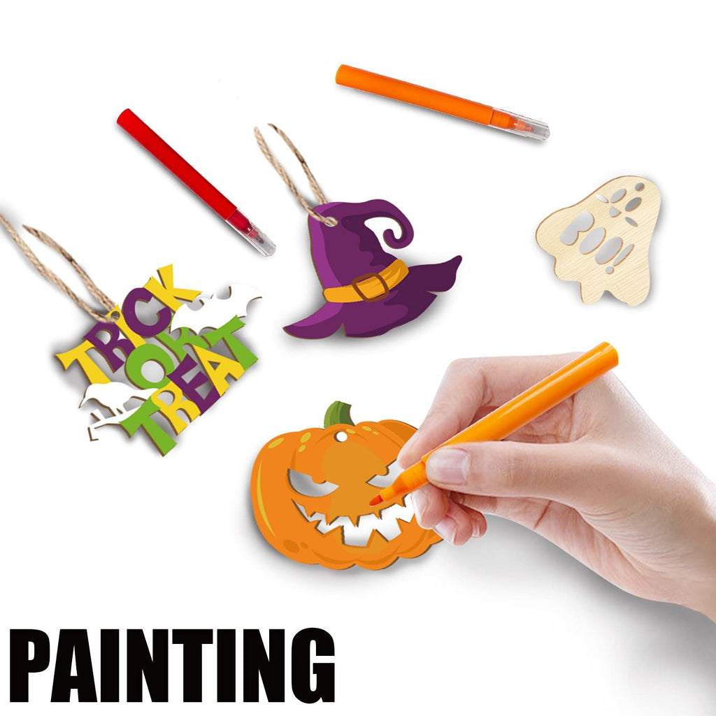 Halloween wooden ornaments including a pumpkin, witch hat, ghost, and 'Trick or Treat' text, with markers and a hand painting the pumpkin.