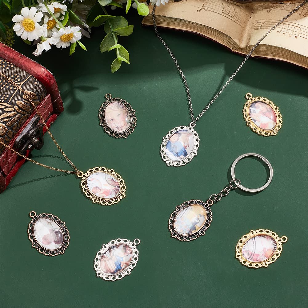 Oval pendant trays with glass domes and various photos, arranged with necklaces and a keychain on a green surface.
