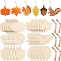 Collection of unfinished wood Thanksgiving ornaments in various shapes including pumpkins, leaves, turkeys, acorns, and squirrels, with hanging holes and twine.