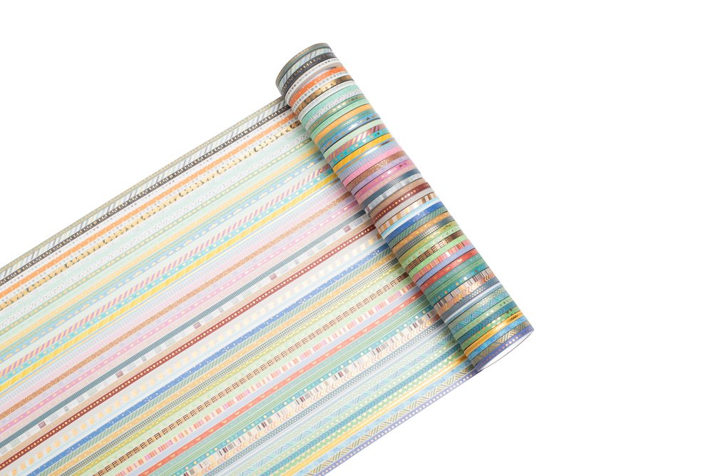 Rolled set of skinny gold foil washi tape with various colorful striped patterns on a white background.