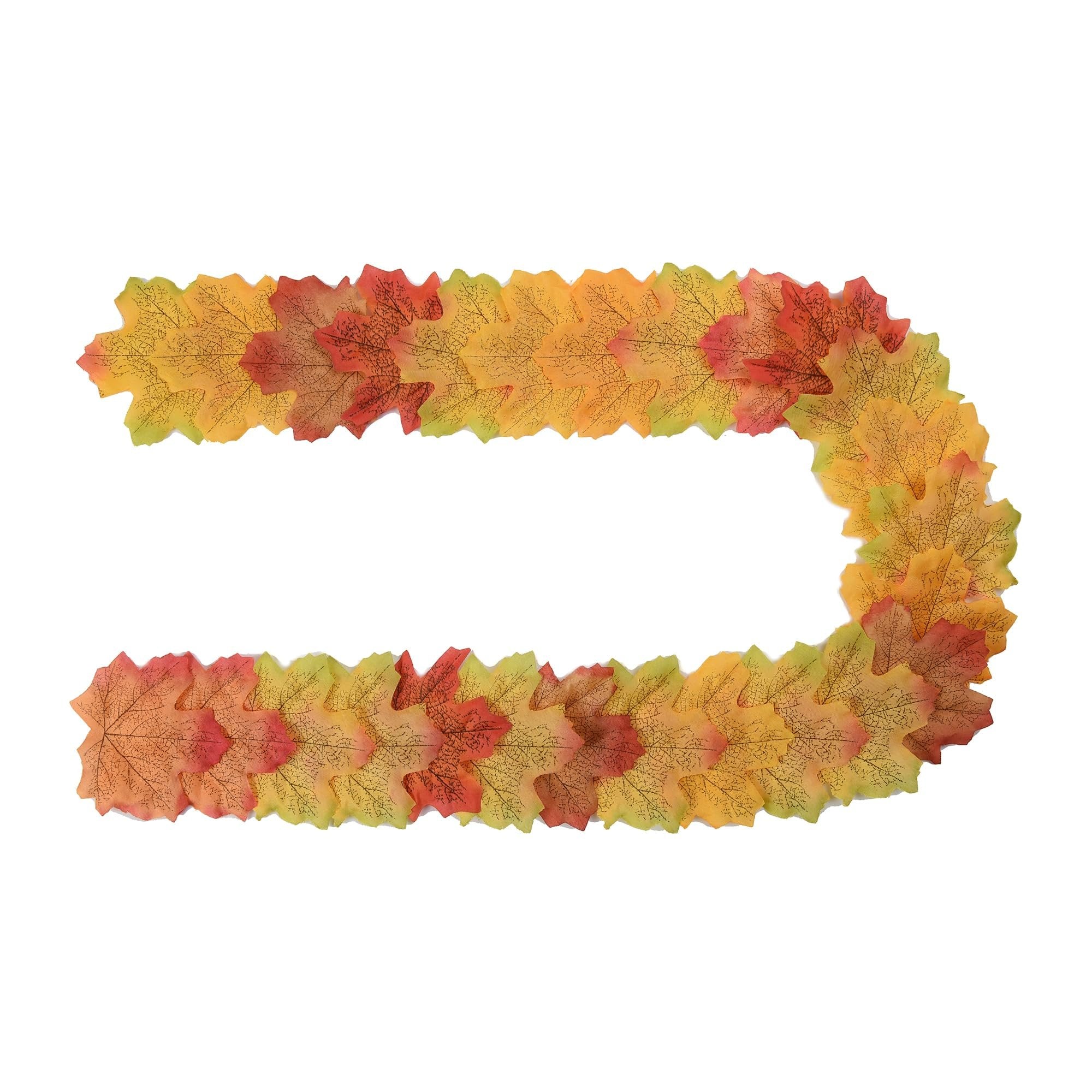 U-shaped arrangement of colorful artificial maple leaves in fall colors on a white background