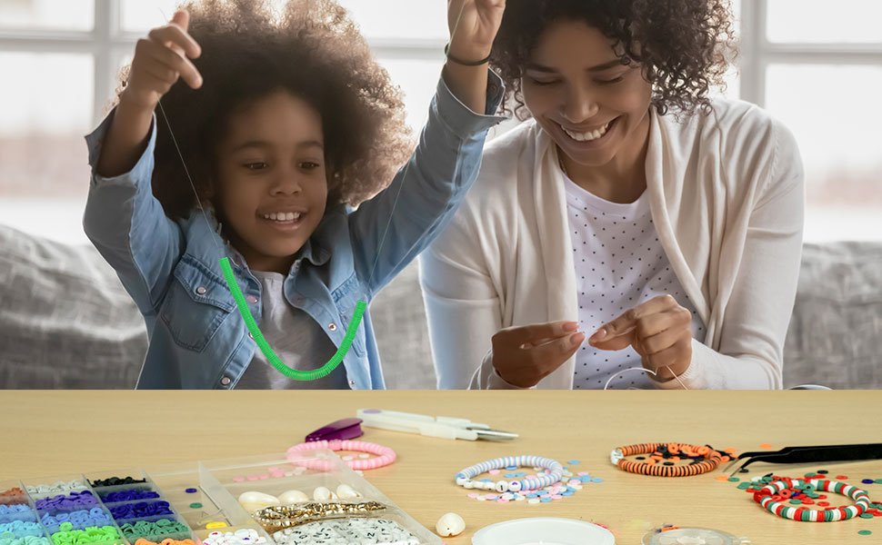 Mother and daughter happily making jewelry with a large bead kit spread out on a table