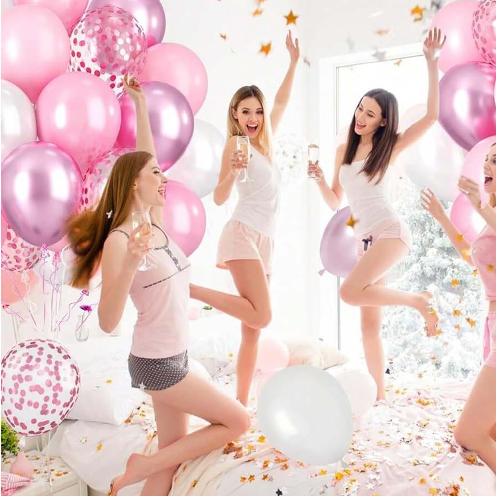Four women in pajamas celebrating with pink and metallic balloons, confetti, and champagne.