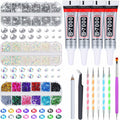 Kit of rhinestones, large gems, and four tubes of B-7000 adhesive glue, with dotting tools, tweezers, and a brush, laid out on a white background.