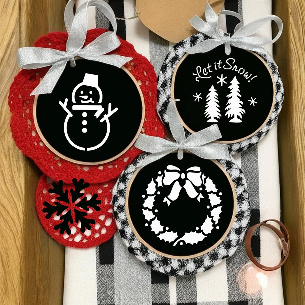 Christmas stencils featuring a snowman, trees, and a wreath, tied with silver ribbons.