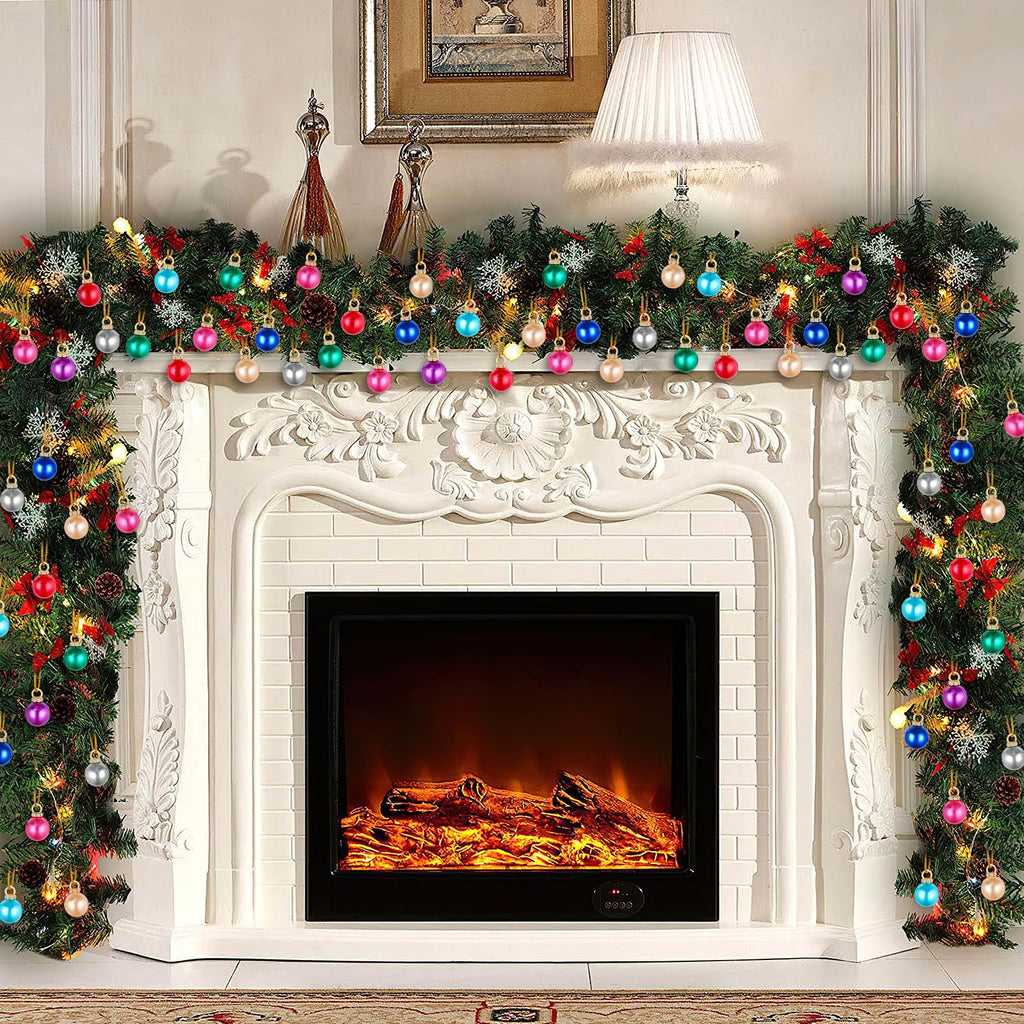 Christmas garland with colorful mini ornaments and lights draped over a fireplace mantel