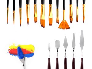 Assortment of art supplies including paint brushes, palette knives, and a smear of colorful paint on a palette knife.