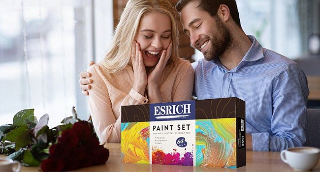 Couple excitedly opening paint set box with colorful abstract art on the packaging.