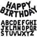 Black foil letter balloons spelling "HAPPY BIRTHDAY" and the full alphabet A-Z