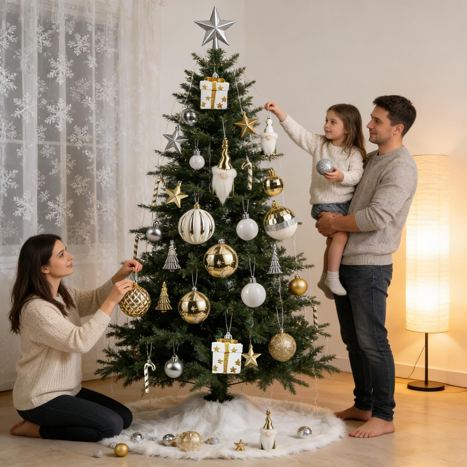 Family decorating a Christmas tree with white and gold ornaments in a cozy living room setting.
